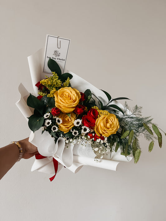 Any Day FloristA bouquet of yellow roses arranged with a red rose spray is the perfect way to cheer someone up and brighten their day! The yellow roses represent friendship, while Serenity Bouquet