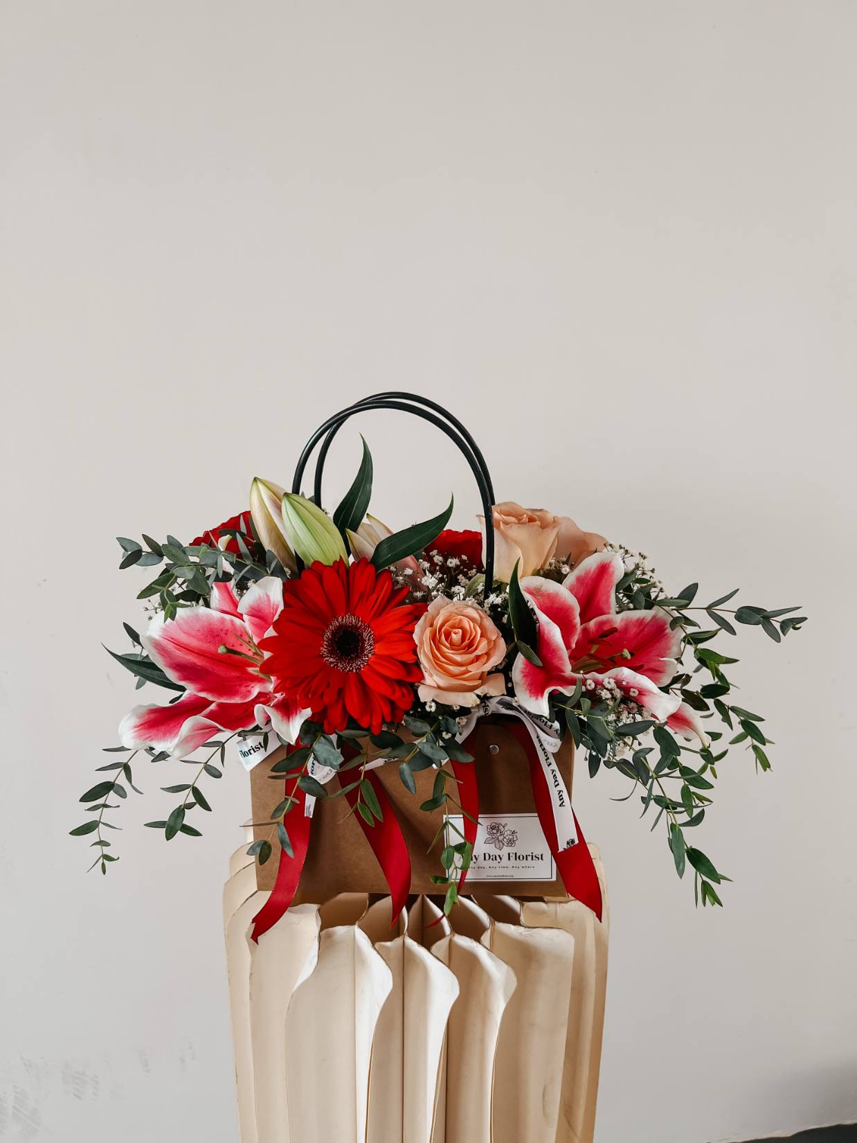 Any Day FloristAnother mother's favorite! With a combination of lilies and roses you can never go wrong with this bouquet! Symbolizes beauty and respectful love to your reciever :)Beau Bloom Bag | Gebera Flowers